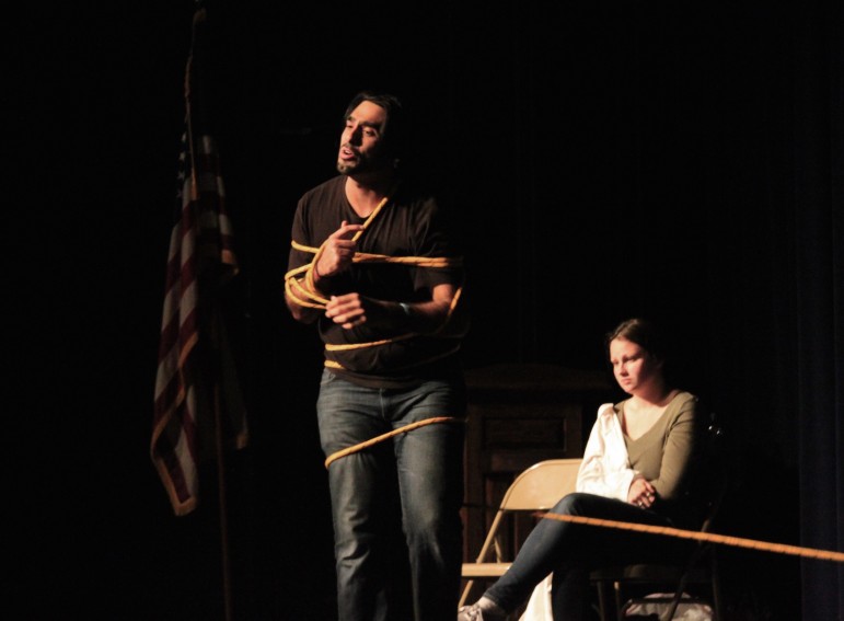 Actors from Improbable Players portray addiction by becoming entangled in a rope.