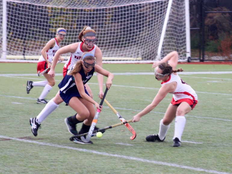 Watertown's Krista Knell knocks the ball away from a Wilmington player in the Raiders' North Section quarterfinal victory.