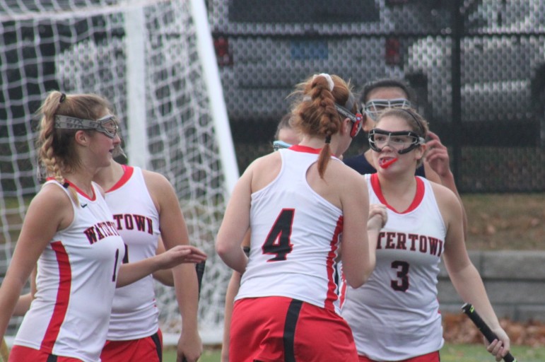 Watertown senior Michaela Antonellis, 3, celebrates with senior Ally McCall after Antonellis scored the Raiders' second goal against Wilmington.