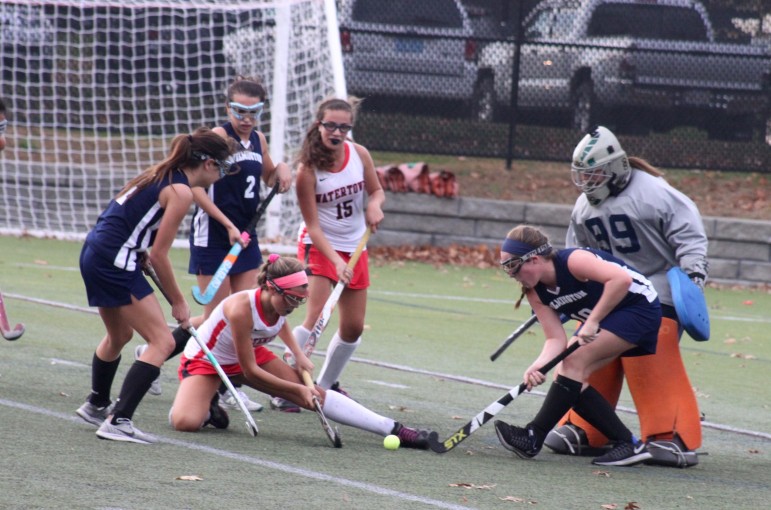Watertown's Gabby Venezia battles Wilmington defenders in front of the net as Olivia Venezia comes to help.