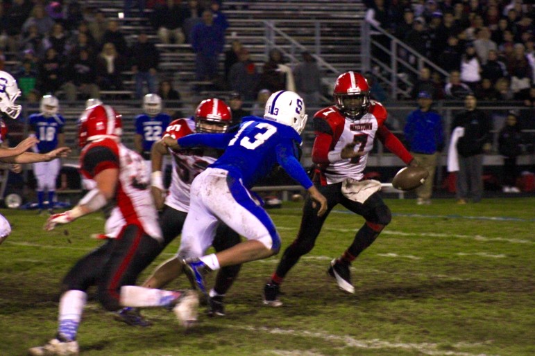 Watertown quarterback Deon Smith looks for room to run in the North Section final at Stoneham.