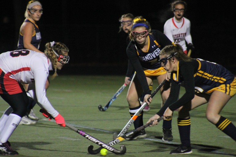 Watertown junior Aurora Fidler dribbles through Hanover defenders in the state semifinal at Canton High School.