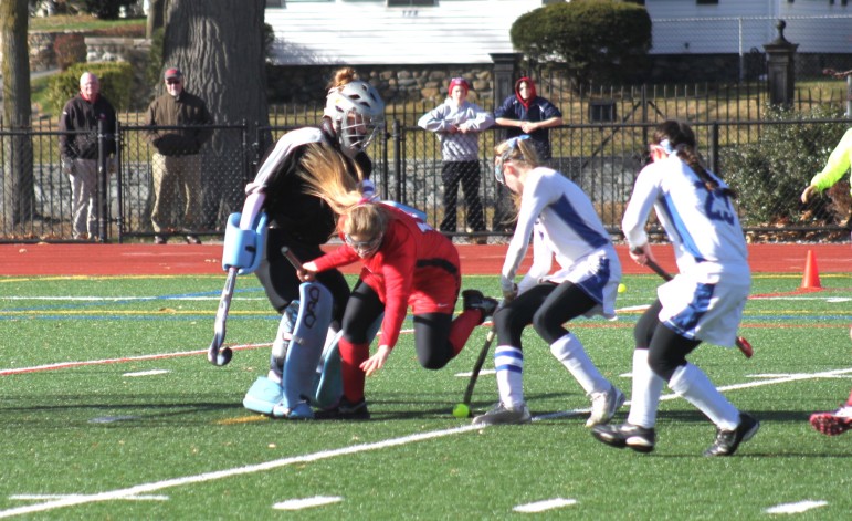Watertown junior Aurora Fiddler is tripped by an Auburn defender, which led to a penalty stroke that Kourtney Kennedy scored for the final tally in Watertown's 6-0 win.