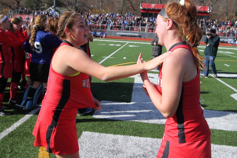 Senior co-captains Michaela Antonellis, left, and Ally McCall embraced after winning the state title in Worcester. They completed their Raider career undefeated.