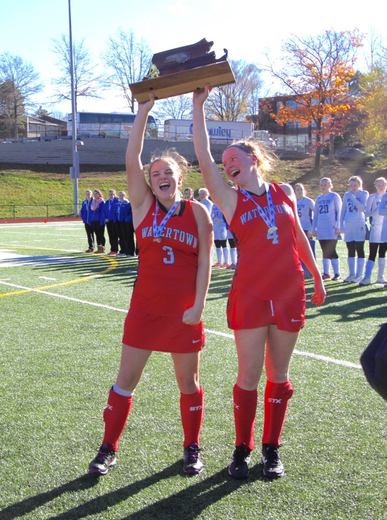 Watertown co-captains Michaela Antonellis, left, and Ally McCall hoist the 2015 MIAA DIv. 2 field hockey championship trophy in Worcester.