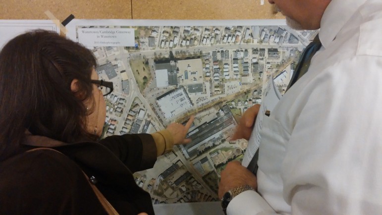 East End Councilor Angeline Kounelis, left, and Assistant Town Manager Steve Magoon look at a map of the new section of the Community Path from Watertown to Cambridge.