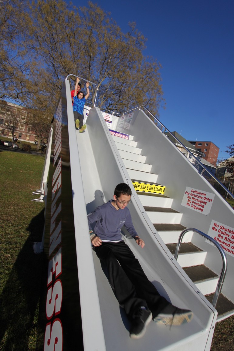 Watertown Middle School students Ryan Webber and Calvin Walter slide down the new multi-fitness equipment at Moxley Field.