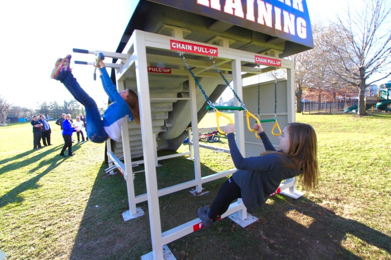 The multi-fitness equipment has many activities, including the pull up areas, being used by Watertown Middle School students Alex Miller, left and Marina Hebeisen.