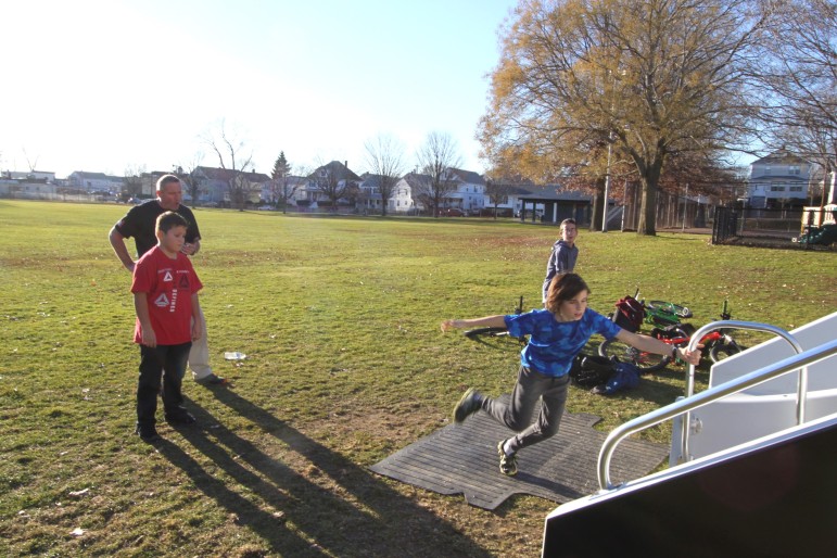 The key to speed running the stairs is grabbing the bar and swinging around, said inventor Collis Brown, who watched students trying to clock their best time.