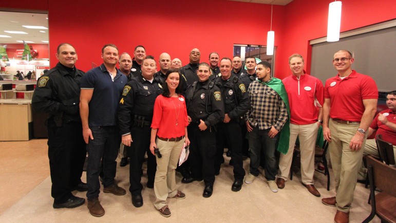 The members of the Watertown Police Department who took part in Shop with a Cop pose with Target employees.