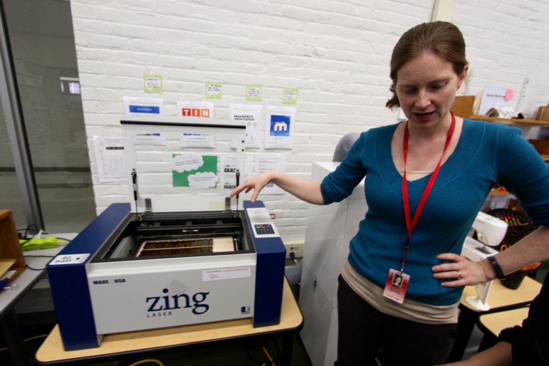 WHS Library Media Specialist Erin Piazza shows laser cutter one of several machines in the Fab Lab.