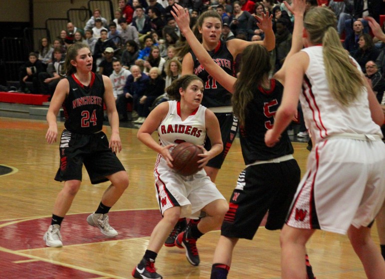 Watertown senior Michaela Antonellis battles the Winchester defense.