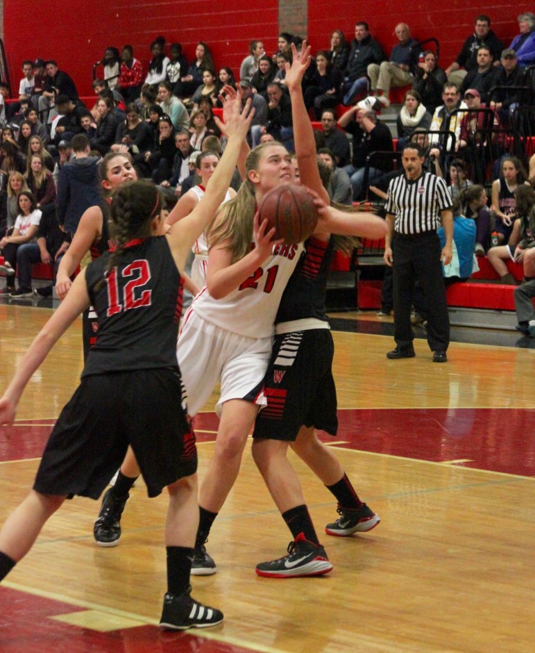 Watertown junior Shannon Murphy takes the ball to the hoop against Winchester.