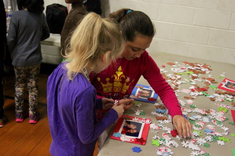 Two members of the Watertown Boys and Girls Club make frames during the Holiday Celebration.