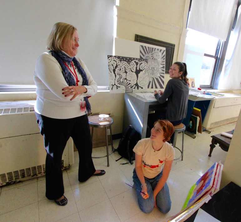 Watertown High School Principal Shirley Lundberg speaks with art students Kira Peterson, center, and Dominika Bondaryk.
