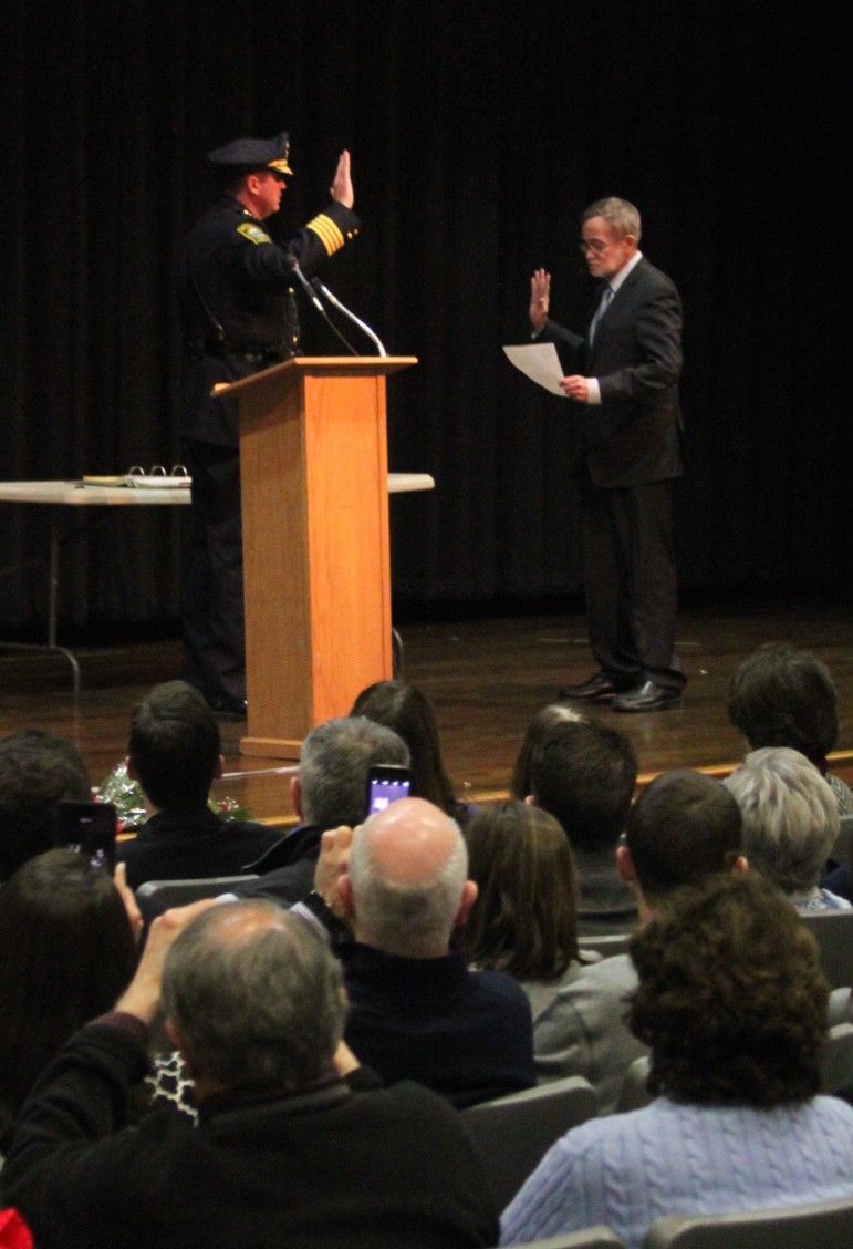 Watertown Police Chief Michael Lawn is sworn in by Town Clerk John Flynn.
