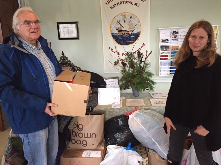 Mark Harris and Watertown Citizens’ Refugee Support Group member Sarah Hamburg load the final donations headed for Syrian refugee camps after a successful, month-long initiative.
