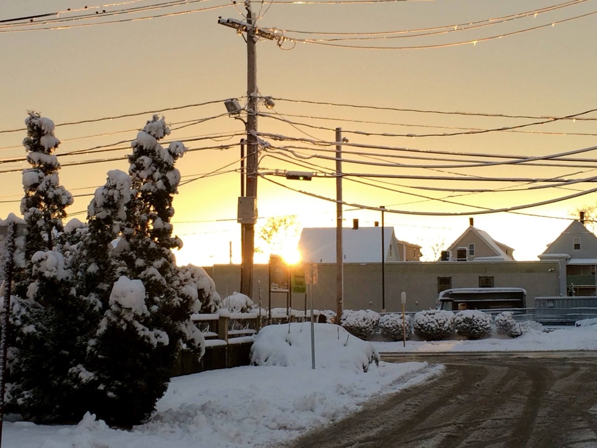 The sun goes down after a long snowy Friday in Watertown.