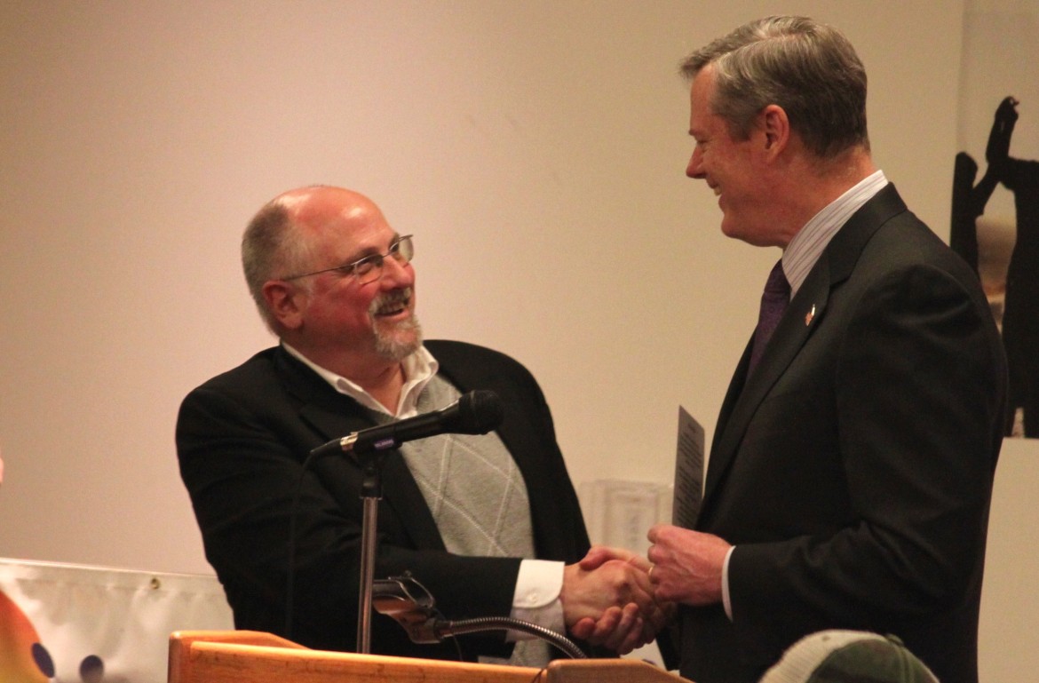 Gov. Charlie Baker, right, congratulates Woody Giessmann, CEO and Founder of Right Turn, after being sworn in to serve on the state Board of Registration and Medicine.