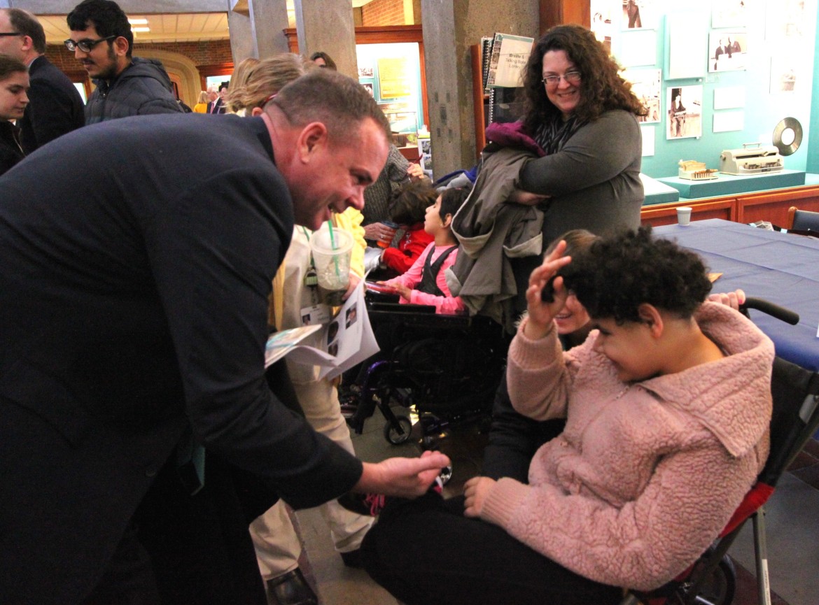 Watertown State Rep. John Lawn speaks with a student at Perkins School for the Blind during Legislator's Day.