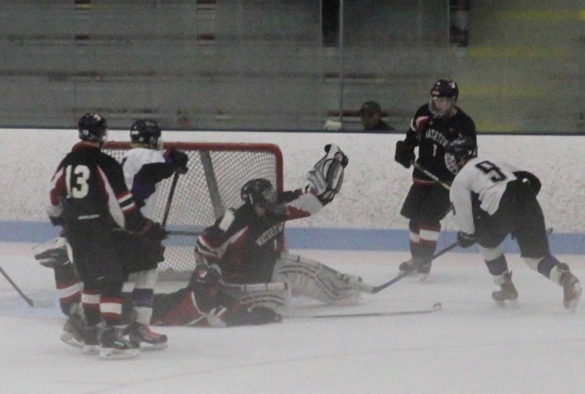Watertown senior goalie Jason Hughes makes a save against Shawsheen in the North Section semifinal at Chelmsford Forum.