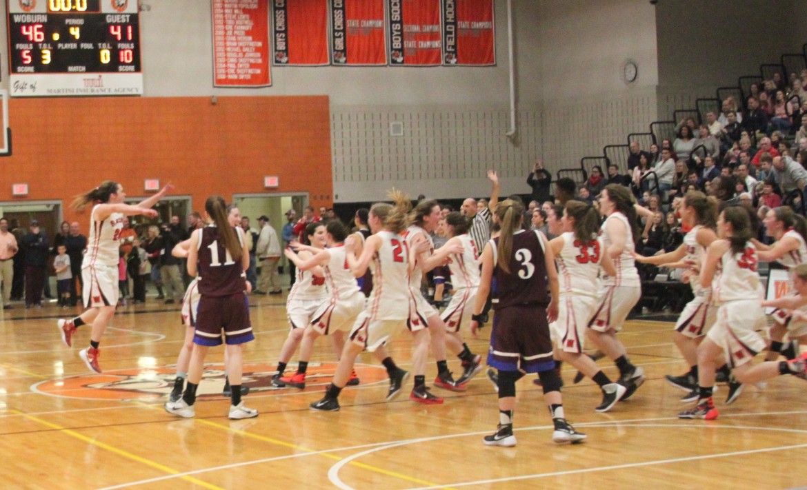 The Watertown girls basketball team rushes the floor to celebrate beating their rivals to claim the Div. 2 North Section Title in Woburn on Saturday.