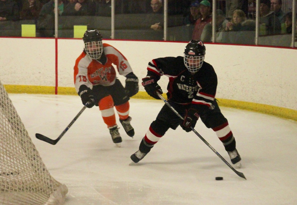 Watertown senior Nick Martino brings the puck around the back of the Wayland net in the North Section final in Woburn. 