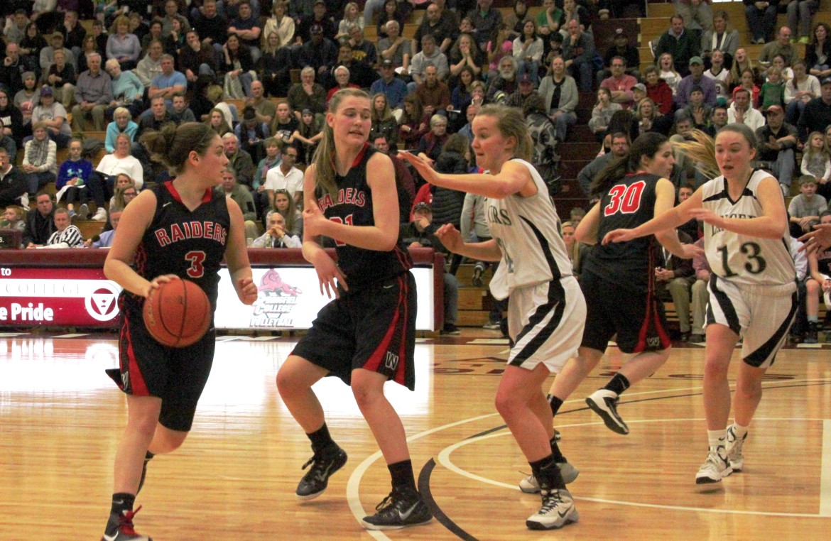 Watertown senior guard Michaela Antonellis dribbles around a screen set by junior center Shannon Murphy.