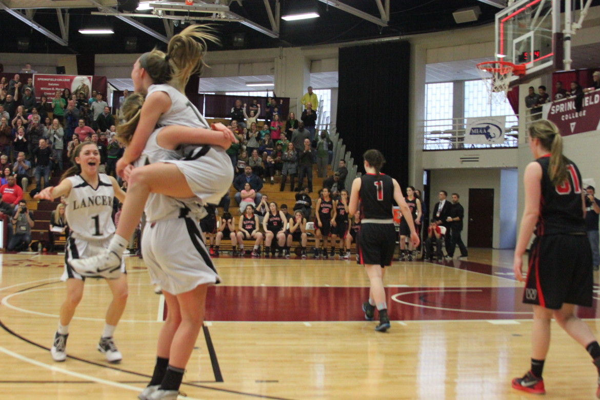 Watertown players Felicia Korte (1) and Katelyn Rourke (31) walk off the court as Longmeadow celebrates winning the Div. 2 girls basketball state final 36-31 over the Raiders in Springfield.