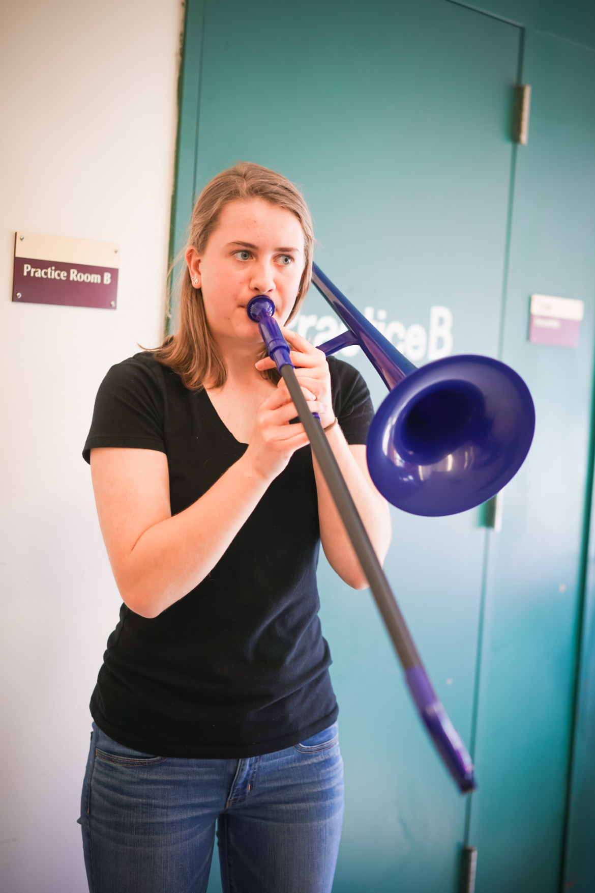 Watertown High School student Catherine Holt plays a pBone – a plastic trombone – which was donated to the district by Ernie Boch Jr.'s charity, Music Drives Us.