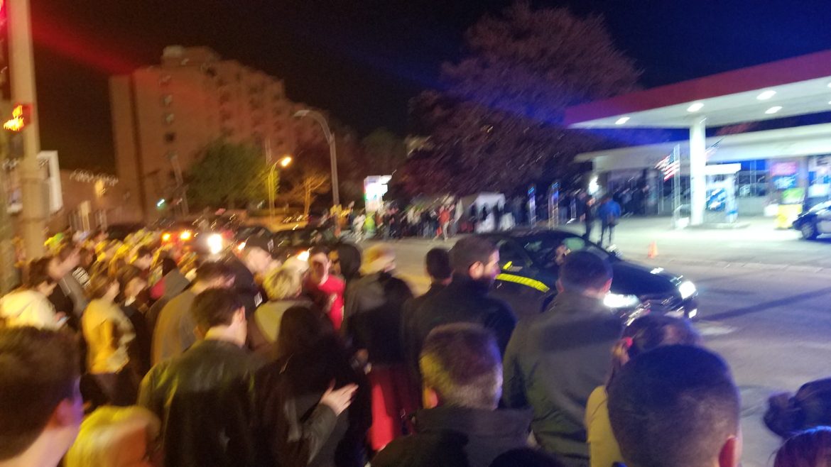 A crowd filled the sidewalk in front of Ricci's Liquor on Main Street to watch the filming of Patriots Day.