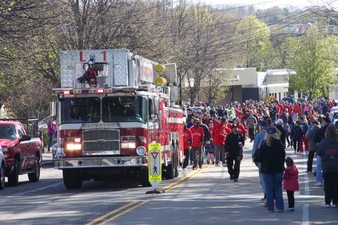 A Watertown Fire ladder truck lead the parade of Little Leaguers from Watertown Square to Casey Park on Watertown Street.