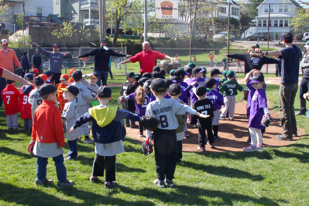 Eddie Murray from the District 10 Little League leads tee ball players in some pre-game stretches.
