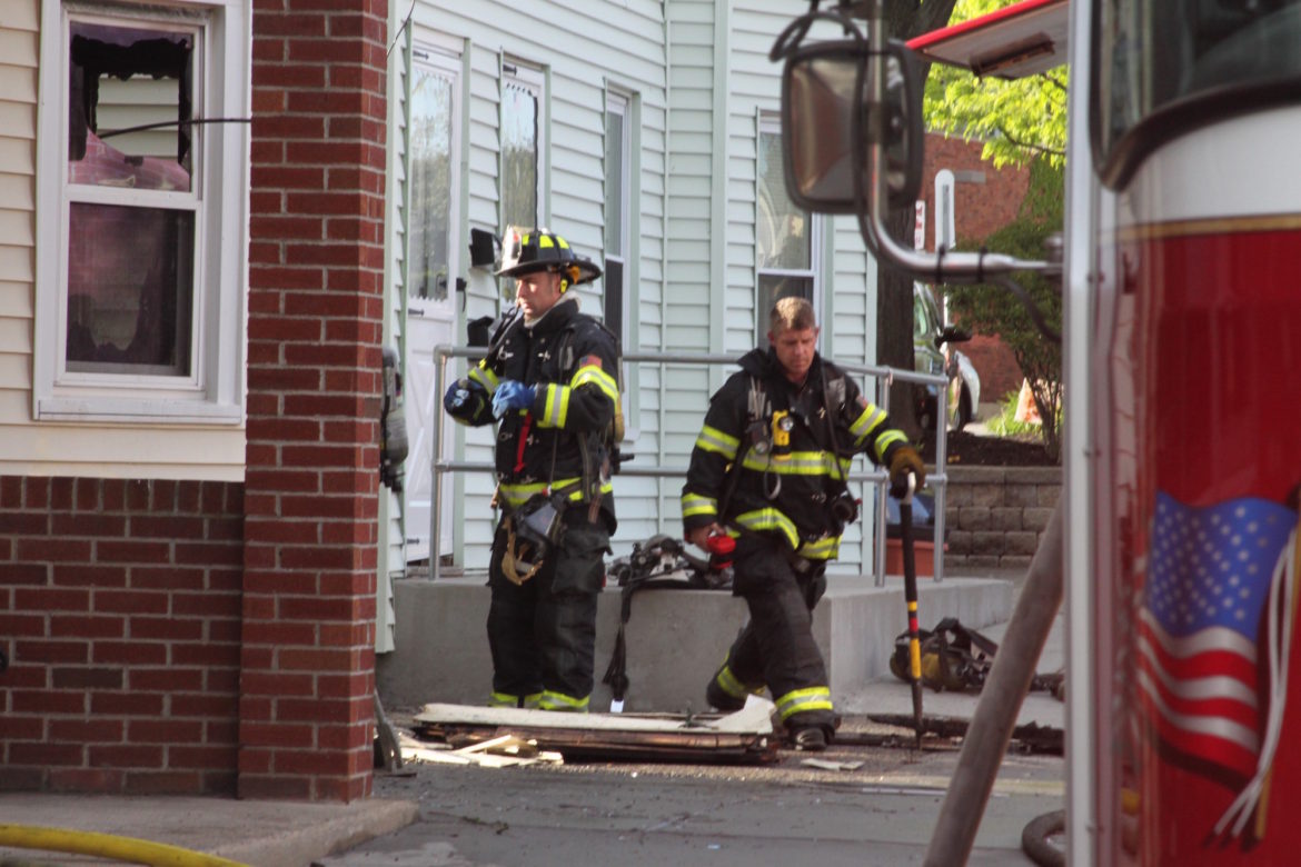 Watertown Firefighters come out of the home on Howard Street after a two-alarm fire.