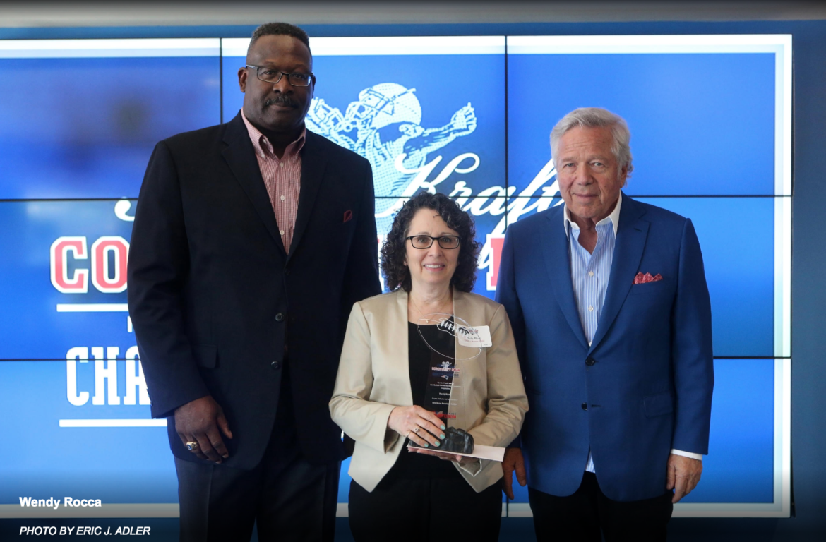 Wendy Rocca, co-founder of Operation American Soldier, received the Myra Kraft Community MVP Award from New England Patriots owner Bob Kraft, right, and Patriots Executive Director of Community Affairs Andre Tippett, left.