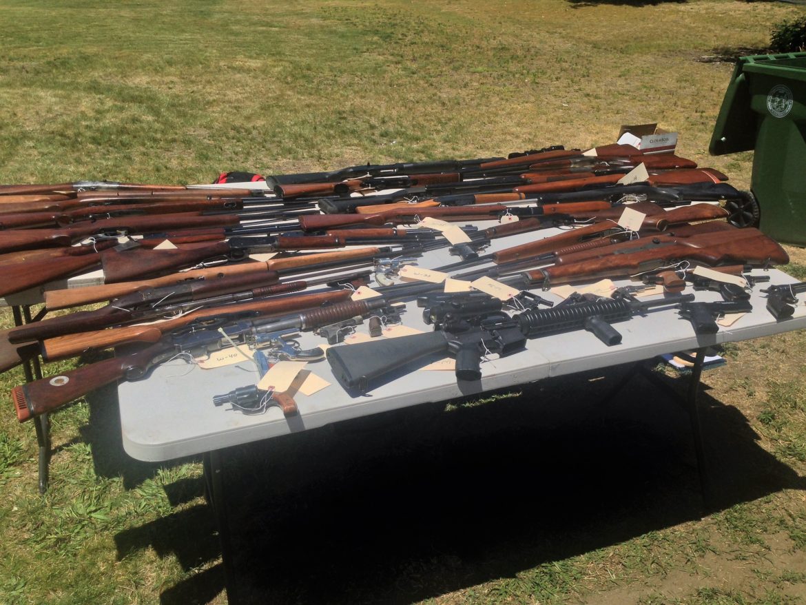 An AR-15 assault rifle, in front, was among the weapons brought to Watertown gun buyback on Saturday.