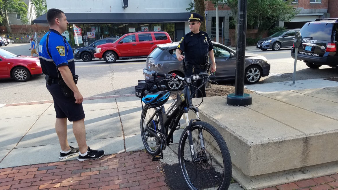 Watertown Police officer Kevin McManus, left, is one of the officers now patrolling on a mountain bike to as an effort to interact more with residents.