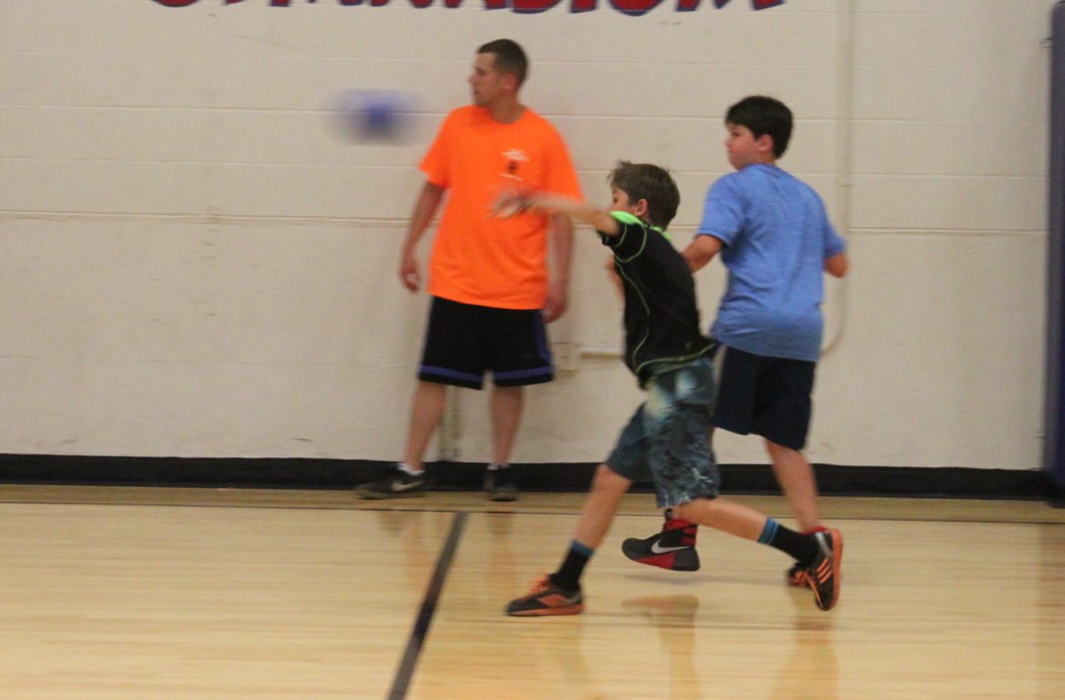 One of the kids who played in the Cops and Kids Dodgeball event hurls a ball in front of off-duy Watertown Police Officer Mike Comick.