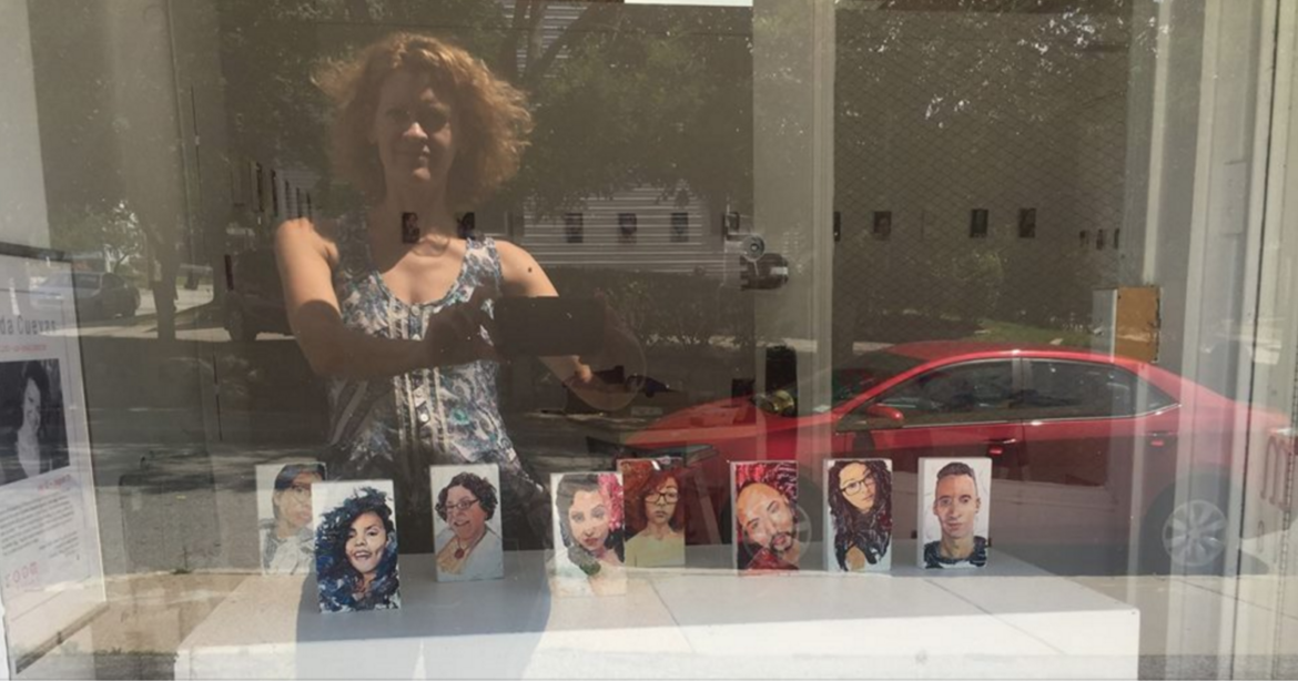 Artist Nayda Cuevas' selfie showing some of her portraits of the victims of the Orlando nightclub shootings which she features in her show at Room 83 Spring.