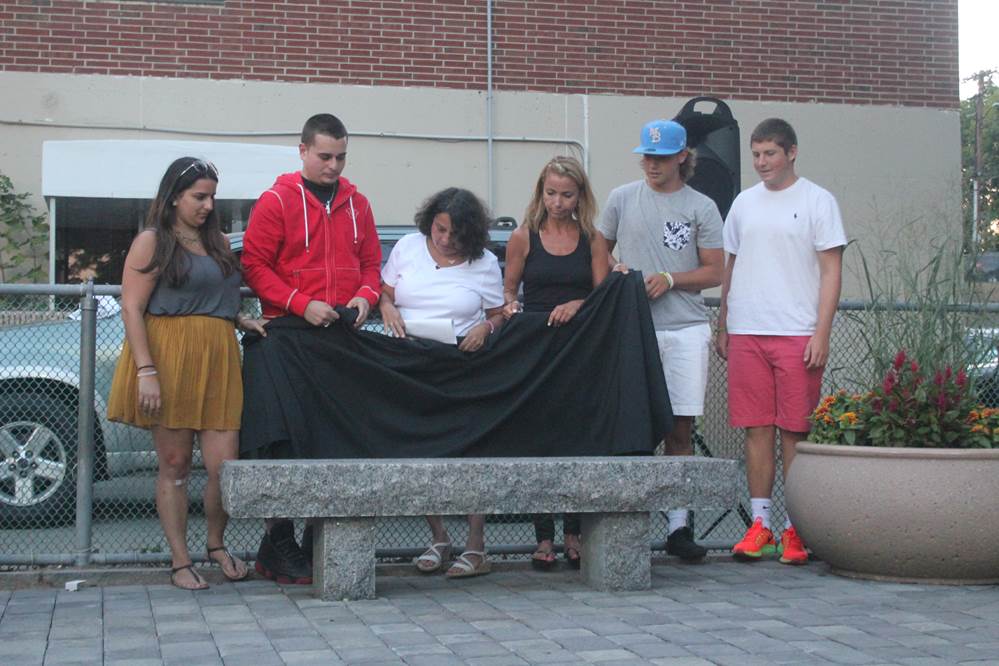 The families of David Timperio and Kenny Vincent unveil the bench dedicated to the former Watertown Summer Basketball League players who passed away in recent years.