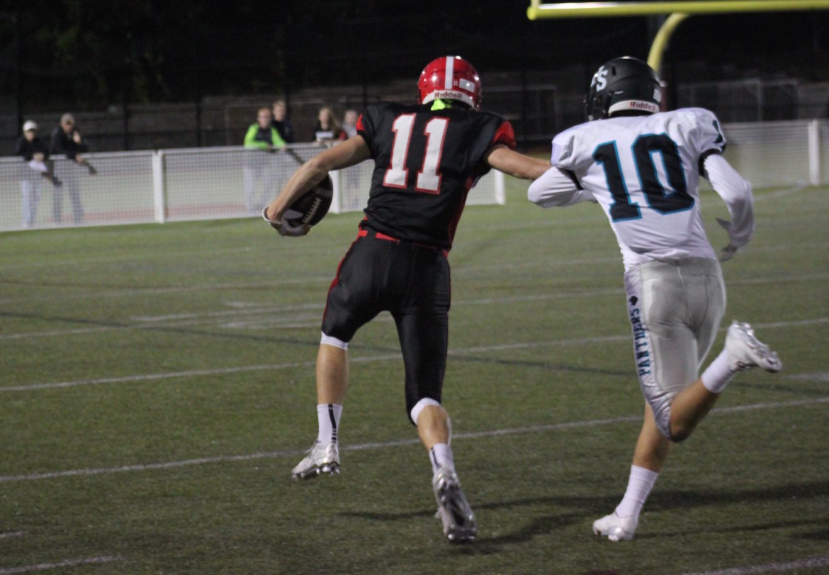 Junior receiver John Korte pushes off a Plymouth South defender on the way to a long touchdown Friday at Victory Field.