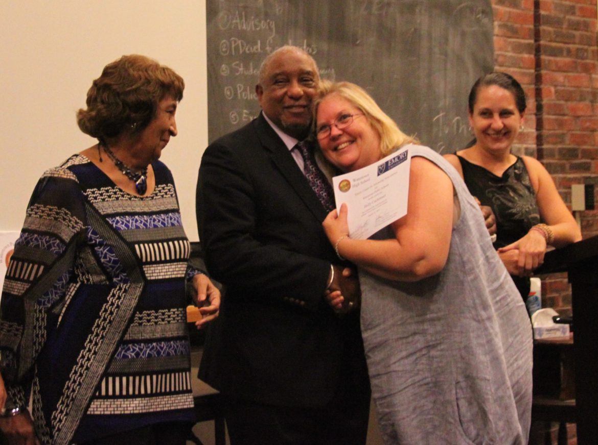 Watertown Middle School Spanish teacher Holly Cachimeul hugs Dr. Bernard Lafayette after she completed her training in Kingian Nonviolence, as Kate Lafayette (left) and WMS Spanish Teacher Ruth Henry (right) watching. Cachimeul and Henry brought the program to the Watertown Public Schools.