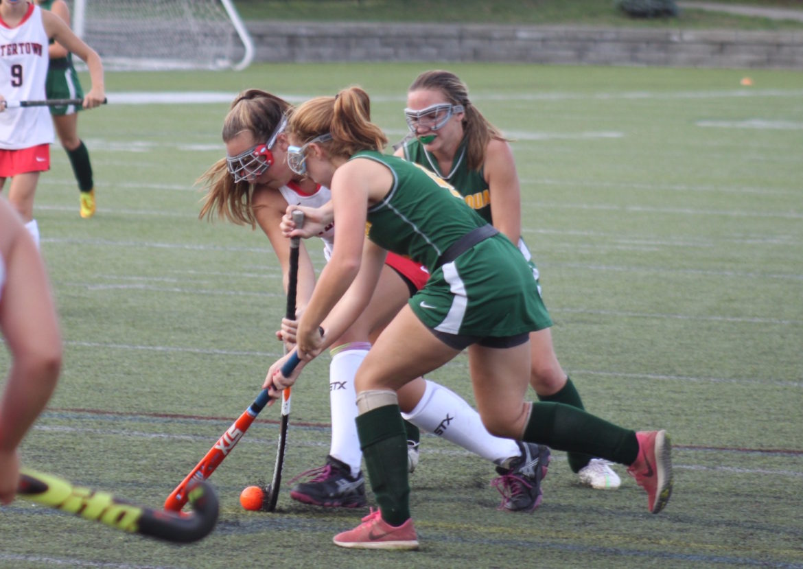 Junior Sydney Poulin battles two Tantasqua defenders in the 6-0 Raiders victory.