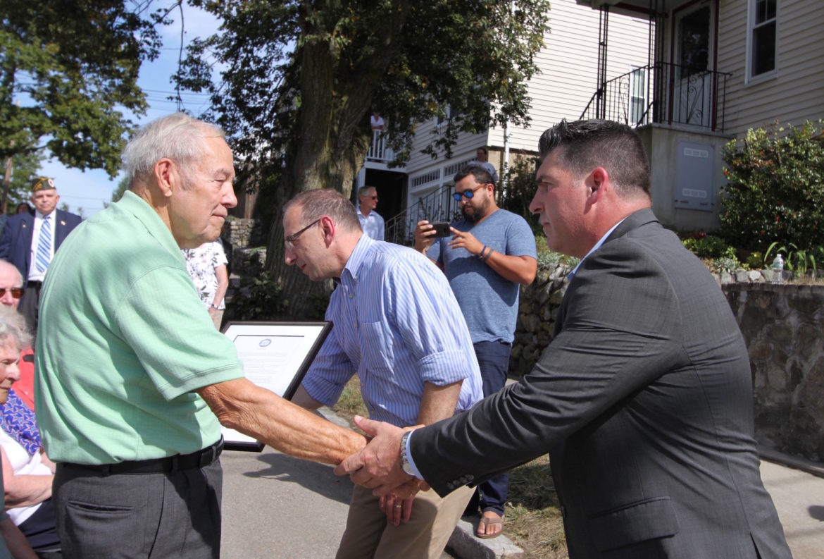 Richard "Dick" Russo, left, shakes hand with Watertown Veterans Service Agent Mark Comeiro at the dedication of a Square in Russo's brother Dominic's name.