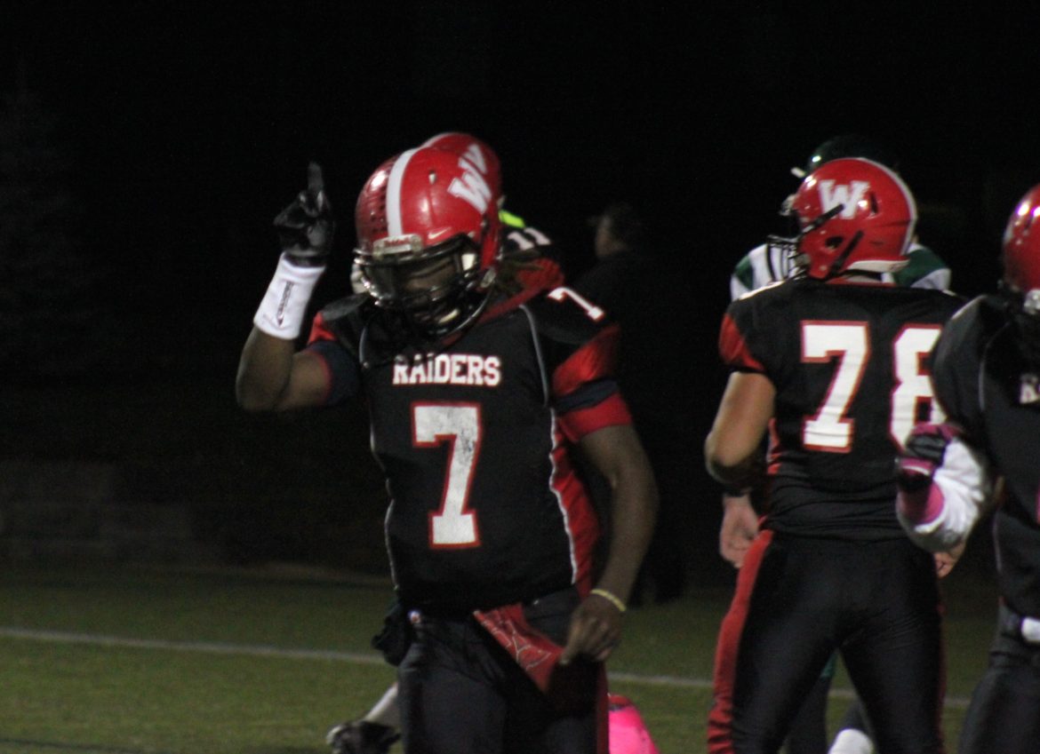 Watertown quarterback Deon Smith points to the heavens after one of his three touchdowns in the playoff game against Austin Prep.