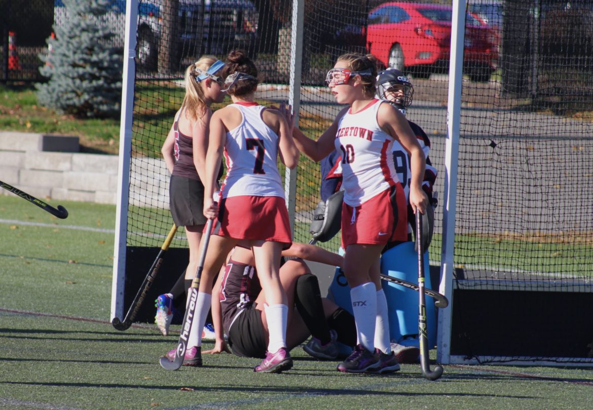 Watertown sophomore Catherine Connors is congratulated by junior Sydney Poulin after Connors scored Watertown's third goal of the game against Weston.