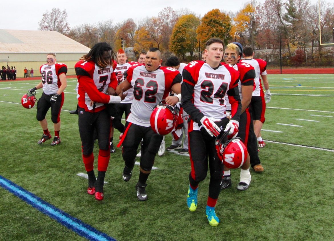The Raiders celebrate after beating Belmont in the 2016 Thanksgiving game. Their coach, John Cacace, called them one of the best teams in Watertown history.