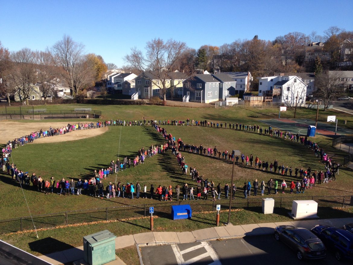 The entire student body and staff of Lowell School created a giant Peace sign in front of the school the day before Thanksgiving.