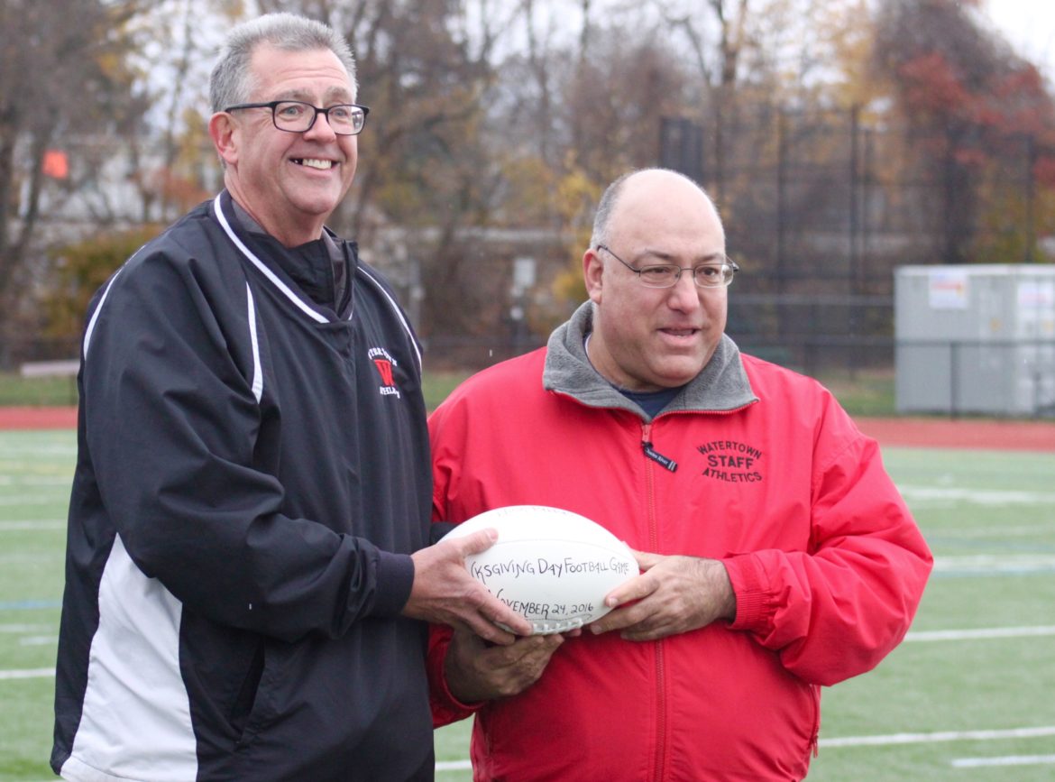 Nick Pappas, right, was an honorary captain at the Thanksgiving Day Football game to honor him for 26 years running the scoreboard at Watertown High School sporting events.