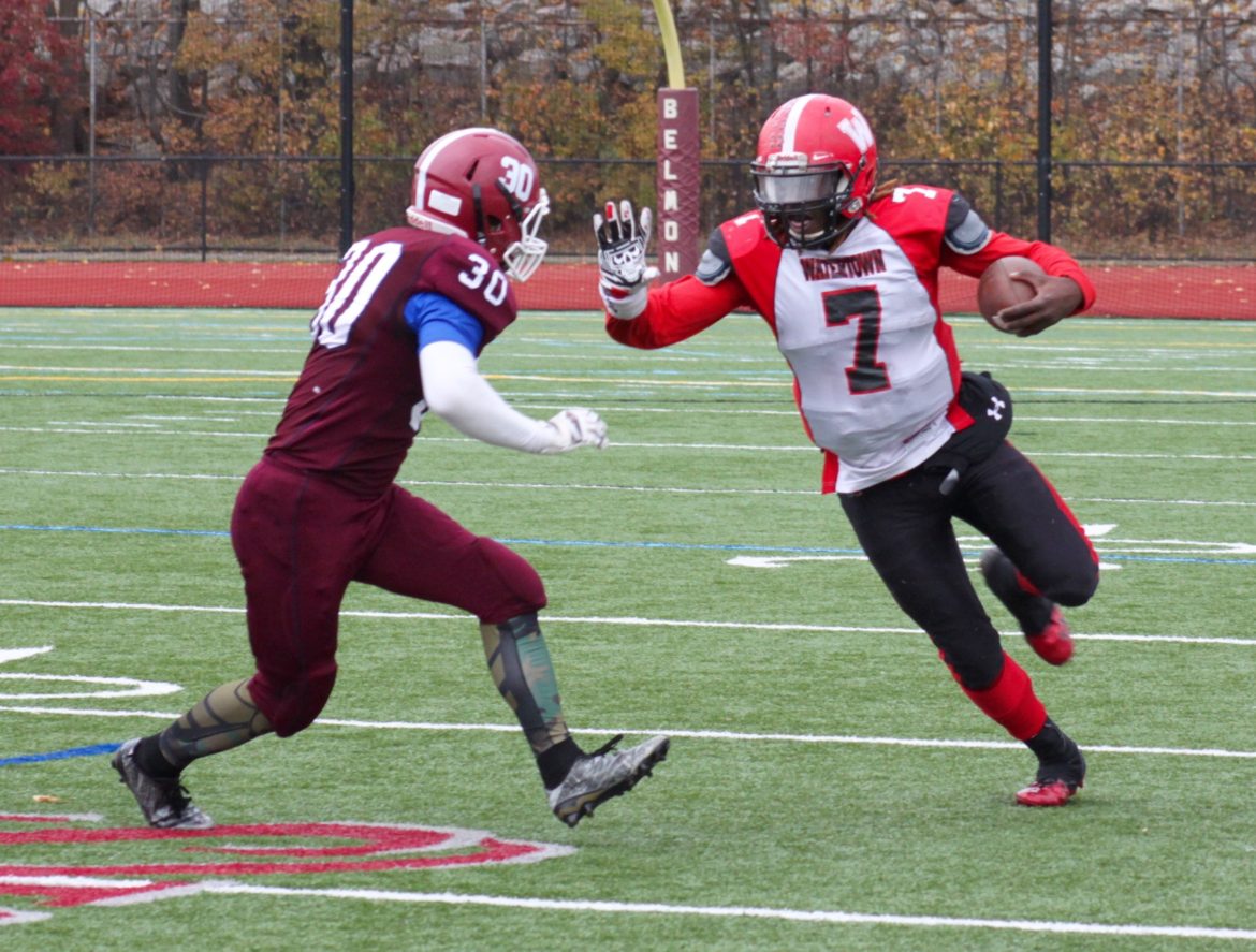 Watertown senior Deon Smith takes on a Belmont defender in the Thanksgiving Day game. He scored a touchdown in the 34-28 victory.